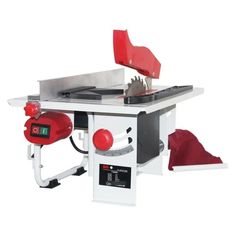 a table sawing machine sitting on top of a white desk with a red hat