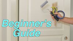 a person holding a pair of scissors and paint rollers in front of a door with the words beginner's guide on it