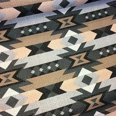 an abstract pattern is shown in black, brown and white