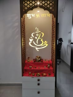 a display case with an illuminated gandap in the middle and other items on it