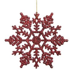 a red snowflake ornament hanging from a chain