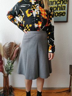 Cool & casual 1970's vintage skirt. It's made if wool and perfect to keep you warm during the cold seasons. It closes with a zipper and a double hook. Size: XS (Model wears wears XS/S, it fits) US 2 | UK 6 | EU 36 Measurements (flat) [ Lenght 57cm | 22,4 inches ] [ Waist 32cm | 12,5 inches ] Colour: Grey. Fabric: 100% new wool. Condition: flawless vintage condition. No holes or stains Vintage Flared Skirt Bottoms For Fall, Vintage Flared Skirt For Fall, Retro Wool Skirt For Fall, Retro Wool Bottoms For Fall, Vintage Workwear Skirt For Fall, Vintage Fall Workwear Skirt, Fall Vintage Workwear Skirt, Fall Vintage Skirt For Workwear, Retro Fall Workwear Skirt