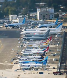 an airport filled with lots of airplanes parked next to each other