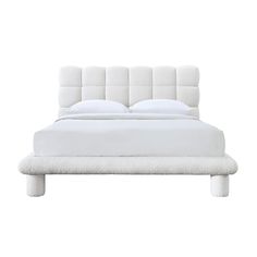 a bed with white sheets and pillows on it