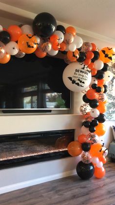 an arch made out of balloons and halloween decorations