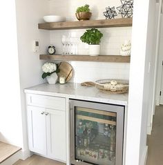 a kitchen with white cabinets and open shelves