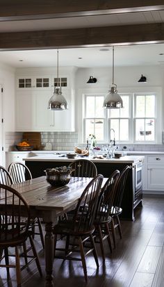 a kitchen filled with lots of wooden furniture