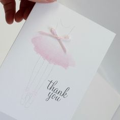 a hand holding a thank you card with a pink ballet tutu skirt on it