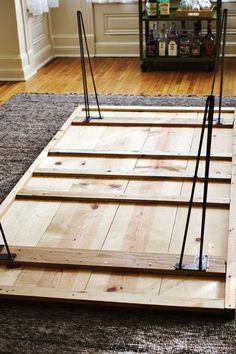 the floor is made out of wood and has metal bars attached to each side, along with other wooden planks