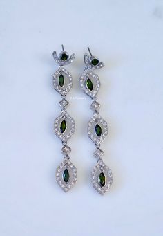 Metal: 14kt White Gold Stone: Diamond and Green Tourmaline Stone Shapes: Marquise And Round Green Tourmaline Weight: 2.20 ctw Diamond Weight: 1 ctw Type Of Backing: Post Weight of entire piece with stones: 11.00 grams Dimensions of Earrings From Top To Bottom Of Earring: 72 mm Customization: We can custom make these earrings and its matching jewelry with any gems and metals of your choice. We can also custom make it longer or shorter. Design Element: Vintage style geometric design. Original Pric Stone Shapes, Amethyst And Diamond Ring, Edwardian Style, Tourmaline Stone, Matching Jewelry, Filigree Design, Gold Stone, Edwardian Fashion, Matching Band