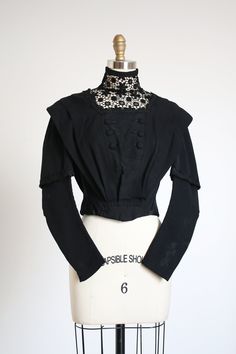 "AMAZING black wool bodice from the Edwardian era. Likely around 1909. Has hooks and eyes up the back. . Label: none . Measurements: { xxsmall } Bust: 33\" Waist: 22\" Length: 17.5\" Sleeve Length: about 25\" . Condition: for it's age I'd say it's nearly excellent! But there are a few minor breaks in that collar and some dirtyness on the sleeves - sold as found. ☆Shop☆ http://www.trunkofdresses.com/" Black Edwardian Blouse, Edwardian Shirt Waist, Elegant Black Corset For Fall, Elegant Black Fall Corset, Fitted Black Vintage Victorian Dress, Black Fitted Boned Bodice Top, Fitted Black Victorian Dress, Black Fitted Victorian Dress, Formal Fitted Victorian Dress With Buttons