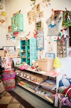 a room filled with lots of toys and other items on shelves next to a wall