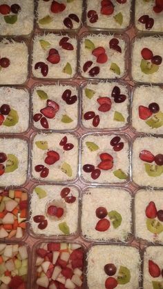 several trays filled with different types of food on top of each other, including fruit and rice