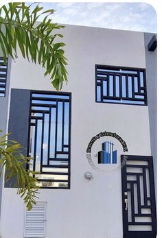 a white building with black shutters and windows