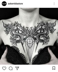 a woman's chest with an intricate tattoo design on the top and bottom part