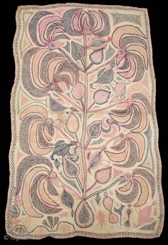 an embroidered cloth with flowers and leaves in pink, blue, grey and white colors