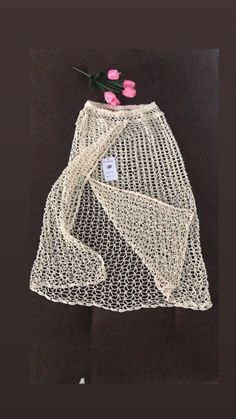 a white net bag with pink flowers on it