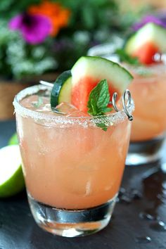 two glasses filled with watermelon, cucumber and mint garnish