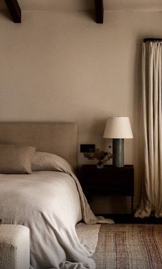 an image of a bedroom setting with bed and lamps