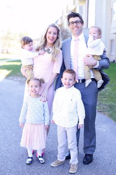 a man, woman and two children posing for a photo