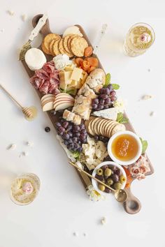 an assortment of cheeses, crackers, and meats on a platter