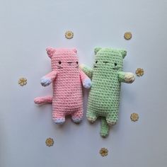 two crocheted stuffed animals laying next to each other