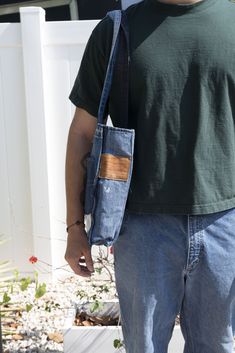 Reworked with multiple pairs of jeans. Inner lining made from a recycled curtain Has two functional pockets on the outside and one on the inside Has Velcro to keep it closed. Bag measurements (not Including strap): 15 INCHES X 13.5 INCHES