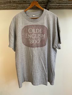 "Vintage 90's faded Alstyle Old English 800 T-shirt. Size large. 90% cotton 10% polyester. 22\" armpit to armpit. 29\" long" Retro Faded T-shirt With Letter Print, Vintage Pre-washed Cotton T-shirt, Vintage Faded T-shirt Pre-washed, Vintage Acid Wash Pre-washed T-shirt, Vintage Gray T-shirt With Text Print, Vintage Faded T-shirt With Screen Print, Vintage Pre-washed T-shirt For Summer, Oversized Acid Wash Vintage T-shirt, Vintage Oversized Washed T-shirt