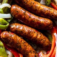 several sausages and peppers are on a platter