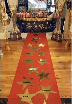 a long red table runner with gold stars on it in front of an american flag