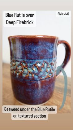 a blue and brown cup sitting on top of a wooden table