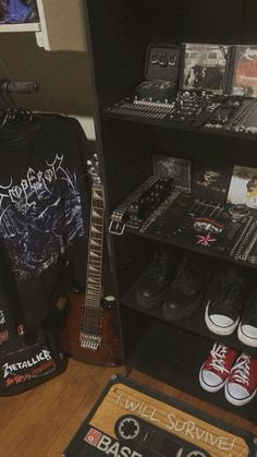 a room filled with guitars, t - shirts and other musical equipment on display in front of a mirror