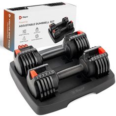 two dumbbells sit on top of a black tray in front of a white box