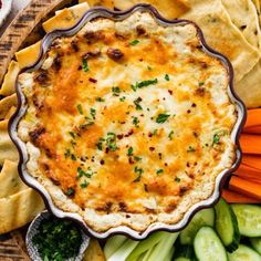 a pie with cheese and vegetables on the side