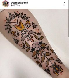 a woman's arm is decorated with flowers and leaves on the left side of her body