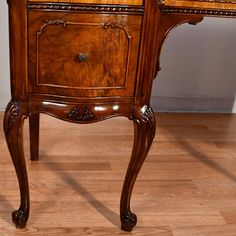 an antique wooden desk with two drawers on one side and a drawer on the other