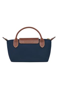 Textured leather trim adds a signature finishing touch to this durable nylon case that's perfectly proportioned for securing your cosmetics while on the go. Water-resistant lining Textile with leather trim Imported Cosmetic Case, Longchamp Le Pliage, Leather Trims, Water Resistant, Nordstrom, The Originals, Leather