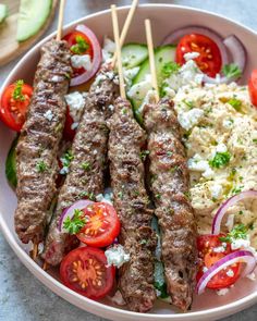 kebabs with tomatoes, onions and cucumbers on a plate