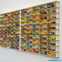 there are many toy cars on the shelves