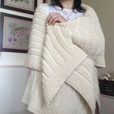 a woman is wrapped up in a blanket and posing for the camera with her hands on her hips