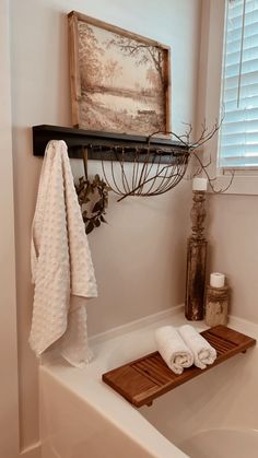 a bathroom with a bathtub and towel rack