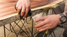 a man is sanding the edge of a wooden table