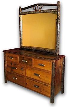 an old dresser with a mirror on top