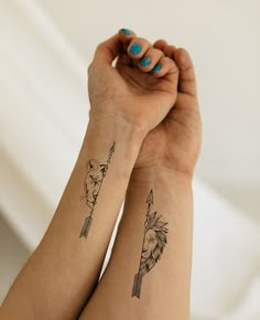 two women with matching tattoos on their arms