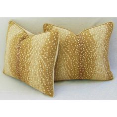 two brown and white pillows with spots on them