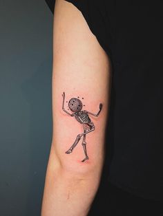 a woman with a skeleton tattoo on her arm