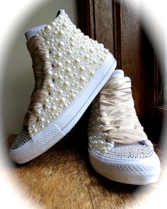 This listing is for one pair of Bridal Converse.  Pricing varies based upon the amount of embellishing you require.  Options for embellishment... 1. Swarovski Crystal Toes ( a color accent may be specified) 2. Swarovski Crystal Stripe down the back of each shoe 3. Swarovski Crystals randomly placed throughout the canvas for a little "sparkle" 4. Flat-Back Pearls hand applied over the canvas sides PLEASE NOTE: The Raw Silk Dupioni Ribbon is an additional cost.  I do not hand cut the fabric.  I order it pre-cut/raw sewn, and do not up-charge my clients for it.  My cost will be passed to you as a direct add-on to the price of this listing. Specify the color pearl you are interested in... Once I have all your information, I can present you with a custom quote. Chuck Taylors Wedding, All Star Cano Alto, Bridal Converse, Bridal Sneakers, Wedding Converse, Wedding Sneakers, Custom Converse, Bling Shoes, Prom Shoes