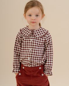 This timeless and elegant blouse crafted from luxurious cotton in Burgundy Vichy, is a winter essential for your girl's wardrobe. Featuring frilled cuffs, a Peter Pan collar and mother-of-pearl buttons fastening the front, it exudes classic charm. Effortless to style and wear, pair it with Amaia's skirts or shorts and matching accessories to complete a sophisticated look. Perfect for any occasion, this beautiful blouse combines comfort and elegance, making it a must-have for the season. Baby Boy Shirts, Girls Special Occasion Dresses, Christening Gowns, Elegant Blouses, Girls Wardrobe, Matching Accessories, Beautiful Blouses, Pearl Buttons, Pan Collar