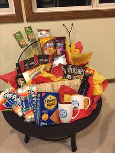 a basket filled with snacks and drinks on top of a table