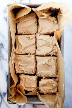 a pan filled with brownies covered in frosting